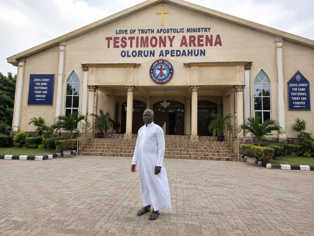 Owolabi Oluwasegun in white ministerial garment outside the church